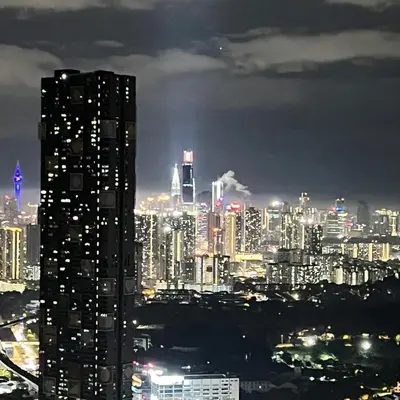 a city skyline at night with a tall building at EKO CHERAS mall kids play room Big sofa MRT 8 pex in Kuala Lumpur