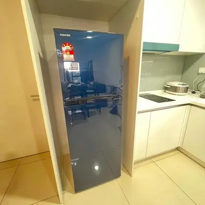 a glass refrigerator in a kitchen with a table at EKO CHERAS mall kids play room Big sofa MRT 8 pex in Kuala Lumpur