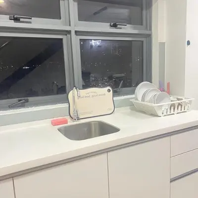 a kitchen counter with a sink and a window at EKO CHERAS mall kids play room Big sofa MRT 8 pex in Kuala Lumpur