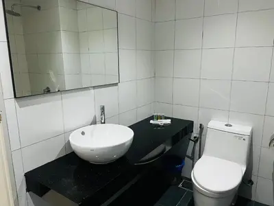 a bathroom with a sink and a toilet at Chambers Kl by MRJ in Kuala Lumpur