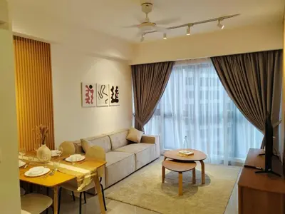 a living room with a couch and a table at Agile SkyView Suites KL in Kuala Lumpur