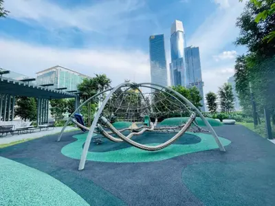 a playground in a park with a swing at Agile SkyView Suites KL in Kuala Lumpur