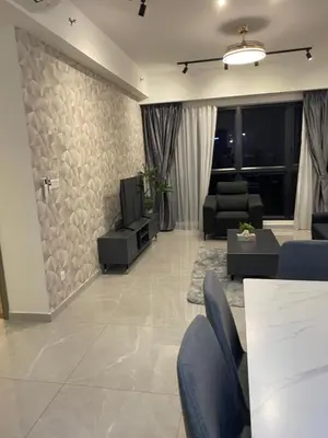 a living room with a couch and a tv at Agile SkyView Suites KL in Kuala Lumpur