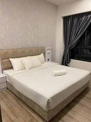 a bedroom with a large white bed with a window at Agile SkyView Suites KL in Kuala Lumpur