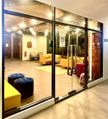 a room with glass doors and furniture in a building at Studio Room at Neu Suites, Jalan Ampang KL in Kuala Lumpur