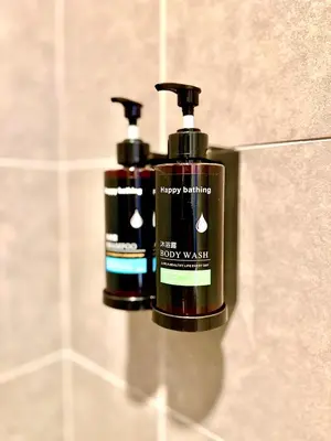 two bottles of may bottles on a wall in a bathroom at Studio Room at Neu Suites, Jalan Ampang KL in Kuala Lumpur