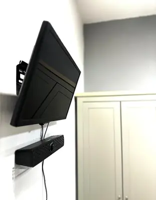 a computer monitor sitting on top of a table at Studio Room at Neu Suites, Jalan Ampang KL in Kuala Lumpur