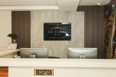 a reception desk with two computers in a room at De Royal Hotel in Ampang