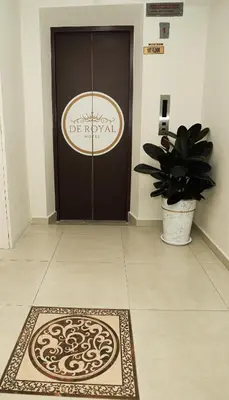a door with a rug in front of it with a potted plant at De Royal Hotel in Ampang