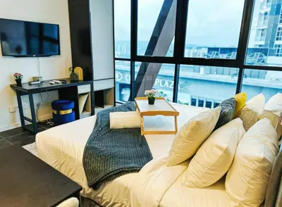 a large bed in a room with a large window at Scarletz Suites KLCC by WSD in Kuala Lumpur