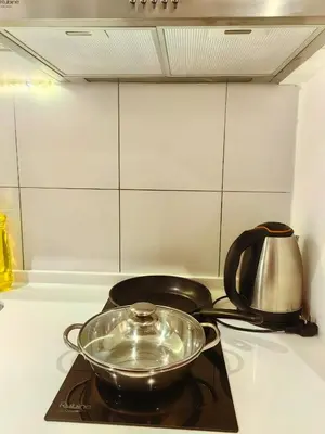 a bowl on top of a stove with a tea kettle at Chamber Residence By SKY Rainbow in Kuala Lumpur