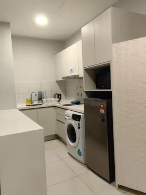 a kitchen with a washing machine and a washer at Chamber Residence By SKY Rainbow in Kuala Lumpur