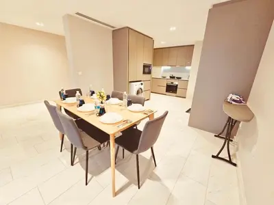 a dining room with a table and chairs and a kitchen at PANORAMIC SUITES at Eaton residence in Kuala Lumpur