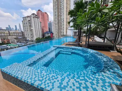 a large blue swimming pool on top of a building at TR Residence 2BR KL View Near MRT LRT Monorail in Kuala Lumpur