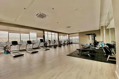a gym with treadmills and ellipticals in a building at TR Residence 2BR KL View Near MRT LRT Monorail in Kuala Lumpur