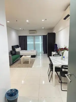 a living room with a couch and a table at SP Home At Mercu Summer Suites in Kuala Lumpur