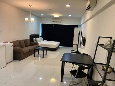 a living room with a couch and a table at SP Home At Mercu Summer Suites in Kuala Lumpur