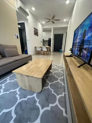 a living room with a couch and a large flat screen tv at Muji Feel Sunway Velocity 2 Link to Mall 2Br in Kuala Lumpur