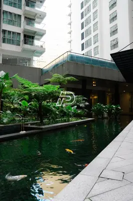 a pond in the middle of a city with buildings at Best View Hostel Regalia KLCC in Kuala Lumpur