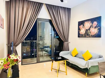 a living room with a couch and a large window at LUCENTIA RESIDENCE BY Glory Home in Kuala Lumpur