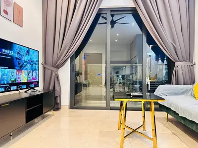 a living room with a tv and a table and a bed at LUCENTIA RESIDENCE BY Glory Home in Kuala Lumpur