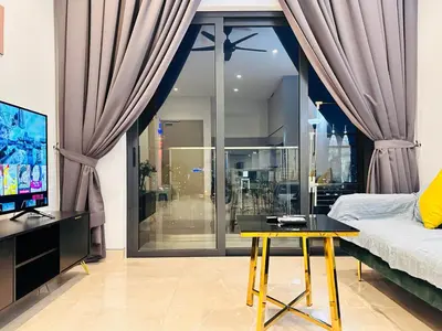 a bedroom with a bed and a tv and a table at LUCENTIA RESIDENCE BY Glory Home in Kuala Lumpur