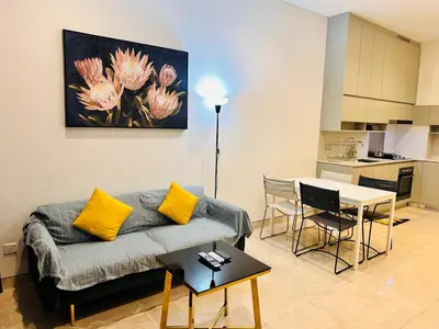 a living room with a couch and a table at LUCENTIA RESIDENCE BY Glory Home in Kuala Lumpur