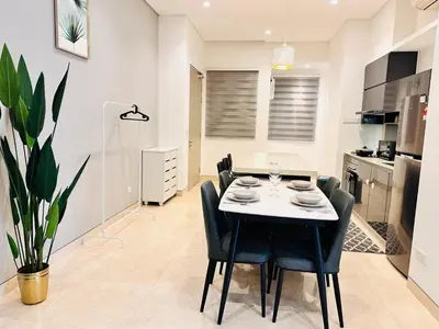a kitchen and dining room with a table and chairs at LUCENTIA RESIDENCE BY Glory Home in Kuala Lumpur
