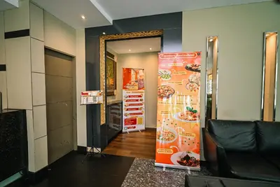 a room with a hallway with a mirror and a door at Kingston Hotel 11 - PWTC, KL in Kuala Lumpur