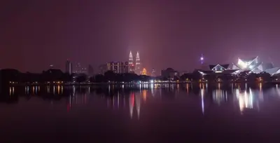a city skyline at night with a large body of water at Kingston Hotel 11 - PWTC, KL in Kuala Lumpur