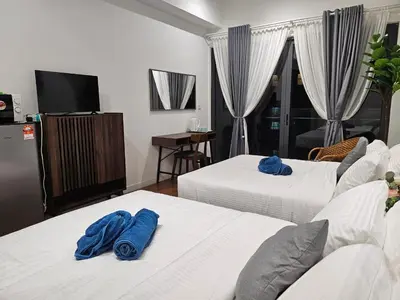 a hotel room with two beds with blue towels on them at Nyiur Premier Residence Ampang Near KLCC Kuala Lumpur in Kuala Lumpur