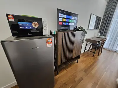 a room with a refrigerator and a tv on top of it at Nyiur Premier Residence Ampang Near KLCC Kuala Lumpur in Kuala Lumpur