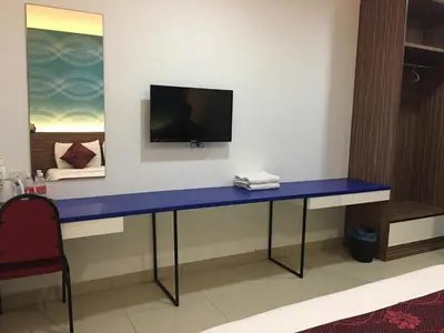 a blue desk in a room with a tv on the wall at Signature Hotel @ Bangsar South in Kuala Lumpur