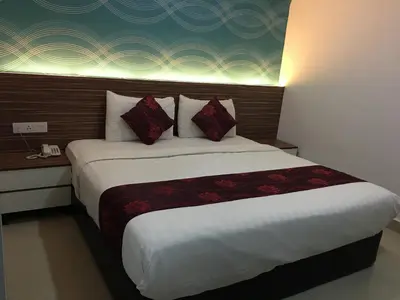 a hotel room with a large bed with red pillows at Signature Hotel @ Bangsar South in Kuala Lumpur