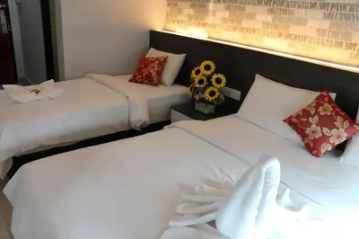 two beds in a hotel room with flowers on them at Signature Hotel @ Bangsar South in Kuala Lumpur