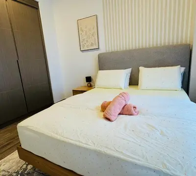 a stuffed animal is laying on a bed at Central of KL 1-5px - 10 mins TRX and Bukit Bintang in Kuala Lumpur
