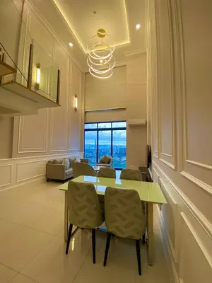 a dining room with a table and chairs and a couch at Societe by Bamboo Hospitality in Kuala Lumpur