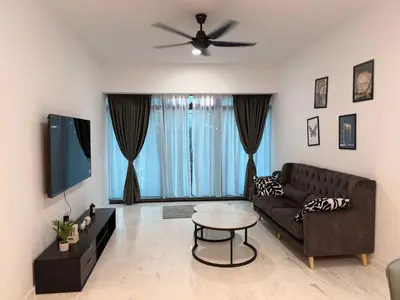 a living room with a couch and a ceiling fan at Eaton Residence KLCC in Kuala Lumpur