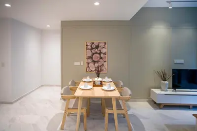 a table and chairs in a room with a painting at Eaton Kuala Lumpur with KLCC Skyline View Pool in Kuala Lumpur