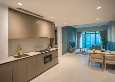 a kitchen with a table and a dining room at Eaton Kuala Lumpur with KLCC Skyline View Pool in Kuala Lumpur