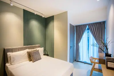 a bedroom with a bed and a large window at Eaton Kuala Lumpur with KLCC Skyline View Pool in Kuala Lumpur