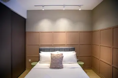 a bedroom with a bed with a headboard at Eaton Kuala Lumpur with KLCC Skyline View Pool in Kuala Lumpur