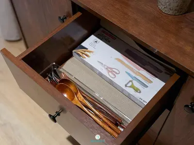 a wooden drawer with utensils in a wooden cabinet at Japandi Studio w Bathtub - Linked to Quill City Mall in Kuala Lumpur