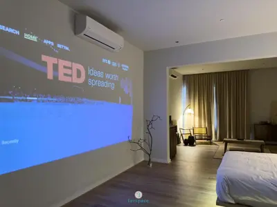 a projection screen in a room with a bed at Japandi Studio w Bathtub - Linked to Quill City Mall in Kuala Lumpur