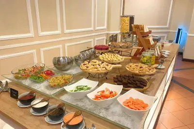 a buffet with many different types of food on a table at Howard Johnson By Wyndham Kuala Lumpur 118 in Kuala Lumpur