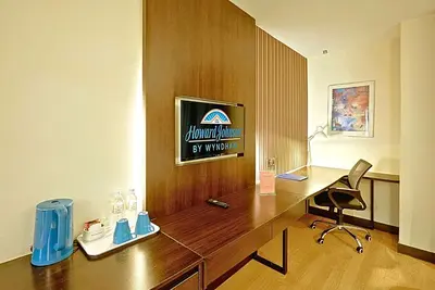 a office with a desk and a sign on a wall at Howard Johnson By Wyndham Kuala Lumpur 118 in Kuala Lumpur