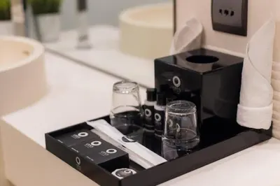 a black coffee maker on a counter in a bathroom at Bukit Bintang Cityscape in Kuala Lumpur