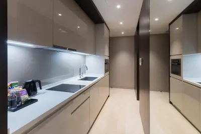 a kitchen with white counters and a sink and appliances at Bukit Bintang Cityscape in Kuala Lumpur