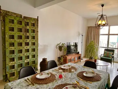 a dining room with a table and chairs at 3BR Vintage design Level 26, KL Sentral City View in Kuala Lumpur