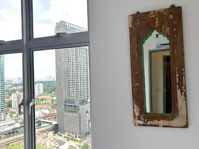 a mirror in a window with a view of a city at 3BR Vintage design Level 26, KL Sentral City View in Kuala Lumpur